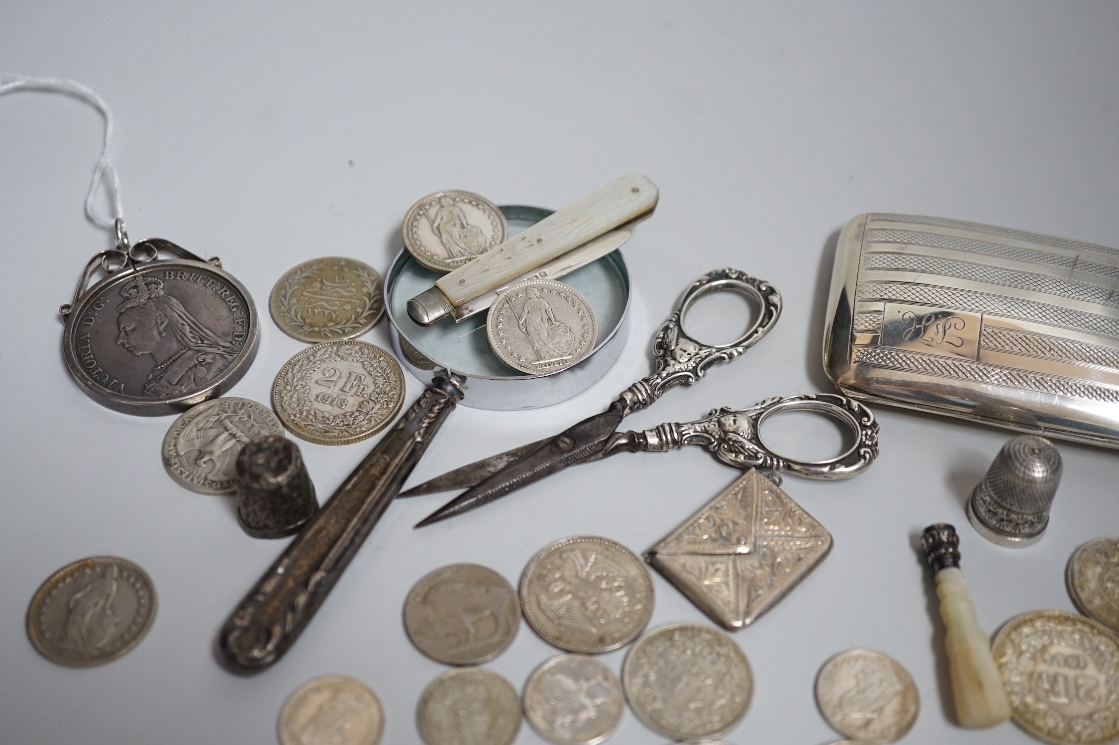 Miscellaneous small silver and white metal items including thimbles, a cigarette case, envelope stamp case, fruit knife, seal, etc and a group of assorted coinage including a silver crown in pendant mount.